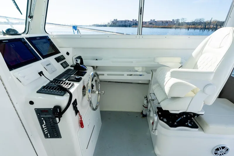 Slide: The Image of 2024 Steiger Craft 31 Fisherman helm with modern controls and comfortable captain's chair. - 33