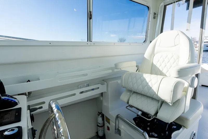 Slide: The Image of 2024 Steiger Craft 31 Fisherman helm with luxurious white captain's chair and steering wheel. - 35