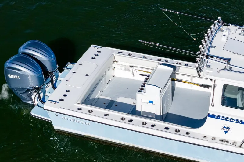 Slide: The Image of 2024 Steiger Craft 31 Fisherman boat with dual Yamaha engines on water. - 5