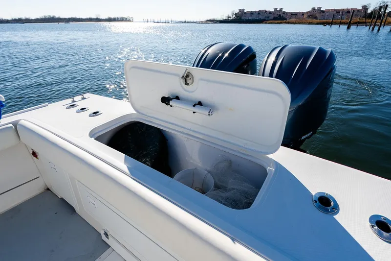 Slide: The Image of 2024 Steiger Craft 31 Fisherman boat with open storage compartment and dual engines on water. - 9