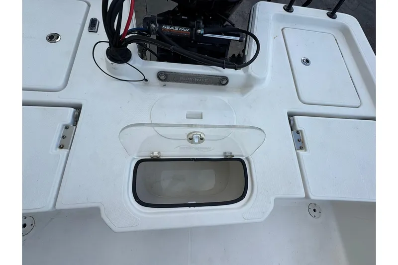 Slide: The Image of 2017 Blue Wave 2200 STL boat deck with storage compartments and Seastar steering. - 10