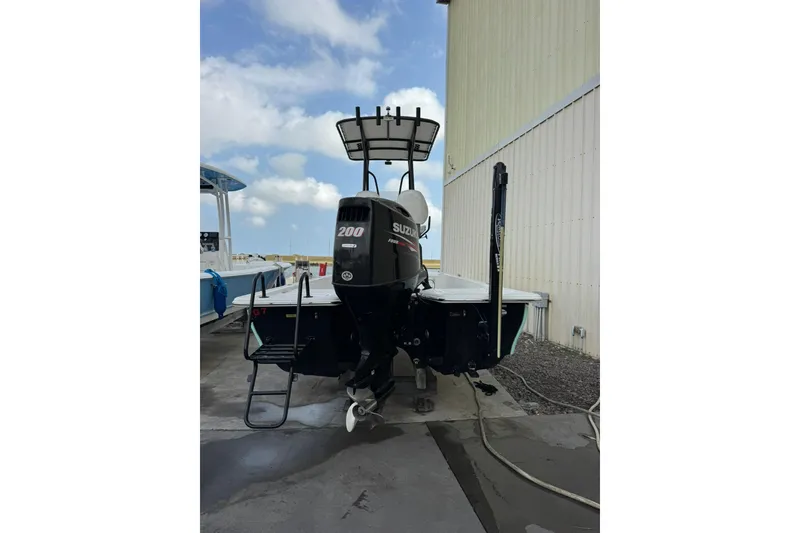 Slide: The Image of 2017 Blue Wave 2200 STL boat with Suzuki 200 outboard motor, docked outdoors. - 5