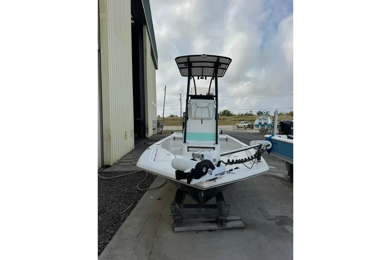 Slide: The Image of 2017 Blue Wave 2200 STL boat on a stand near a large building. - 6