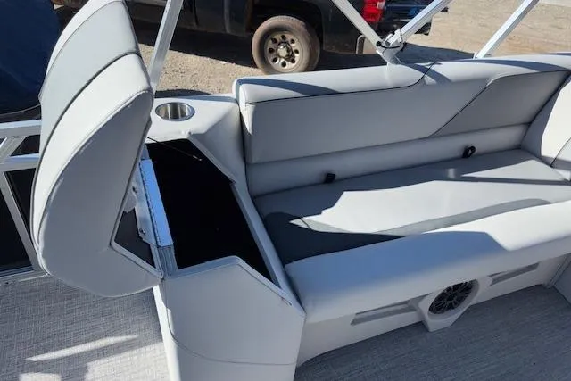 Slide: The Image of 2026 Tahoe Pontoon SP 2385 EL interior with gray seating and storage compartment. - 19