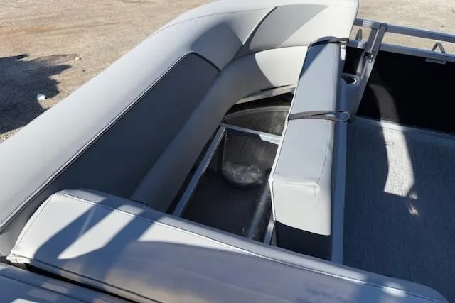 Slide: The Image of 2026 Tahoe Pontoon SP 2385 EL interior seating with storage compartment, gray upholstery. - 23
