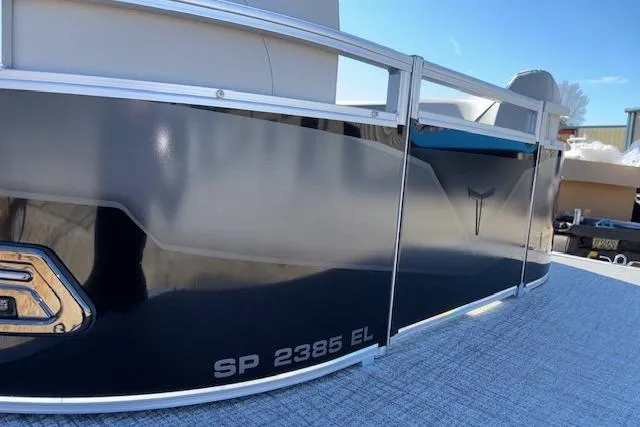 Slide: The Image of 2026 Tahoe Pontoon SP 2385 EL boat, sleek design, side view under clear blue sky. - 3