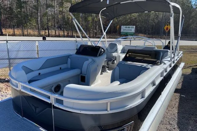 Slide: The Image of 2026 Tahoe Pontoon SP 2385 EL boat with canopy, parked outdoors. - 6
