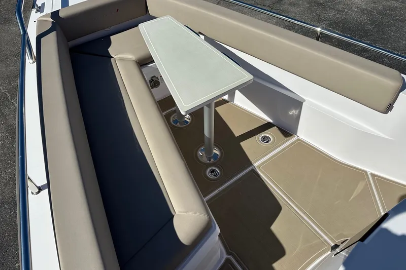 Slide: The Image of 2022 Axopar 28 CABIN boat interior with beige seating and a central table. - 11
