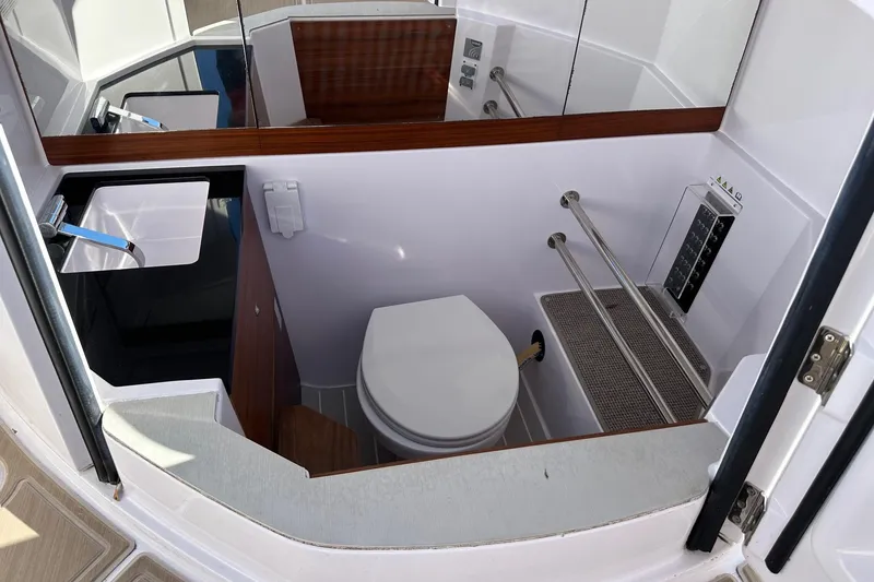 Slide: The Image of 2022 Axopar 28 CABIN boat interior bathroom with sink and toilet. - 17