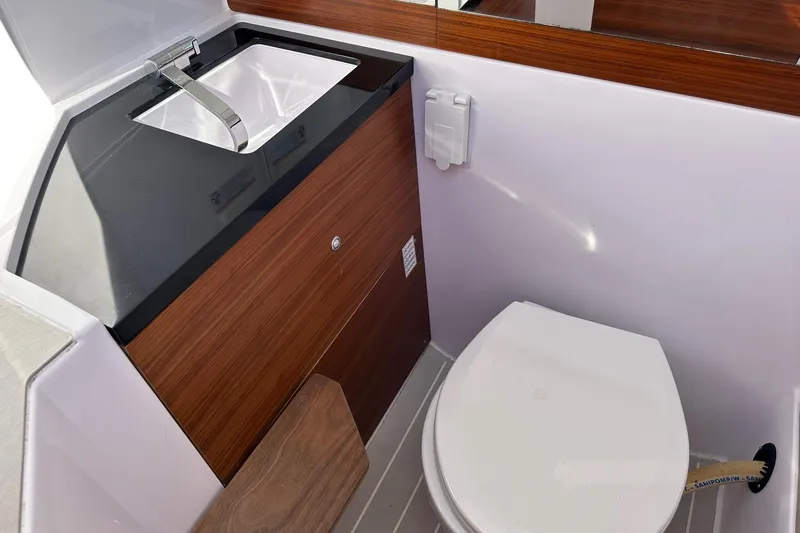 Slide: The Image of 2022 Axopar 28 CABIN bathroom with modern sink and toilet. - 19
