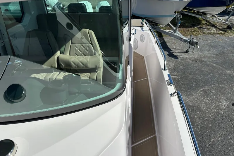 Slide: The Image of 2022 Axopar 28 CABIN boat with sleek design and comfortable seating. - 20