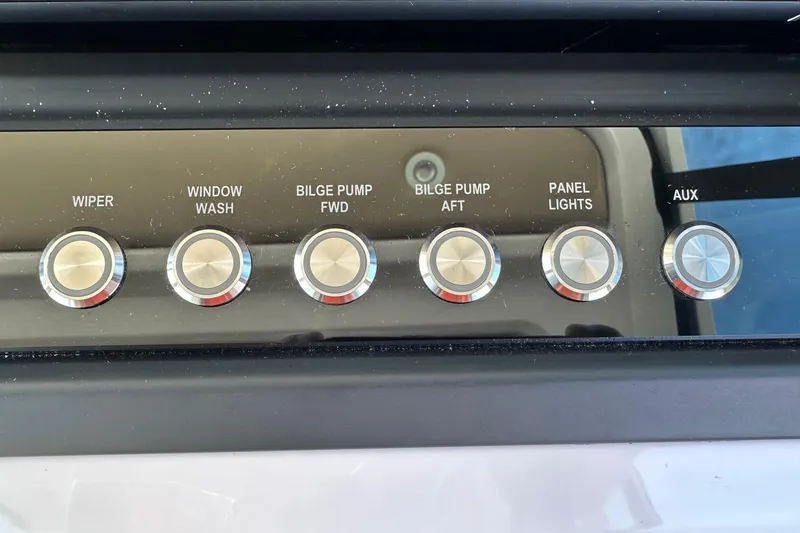 Slide: The Image of Control panel of 2022 Axopar 28 CABIN with labeled buttons for various functions. - 25