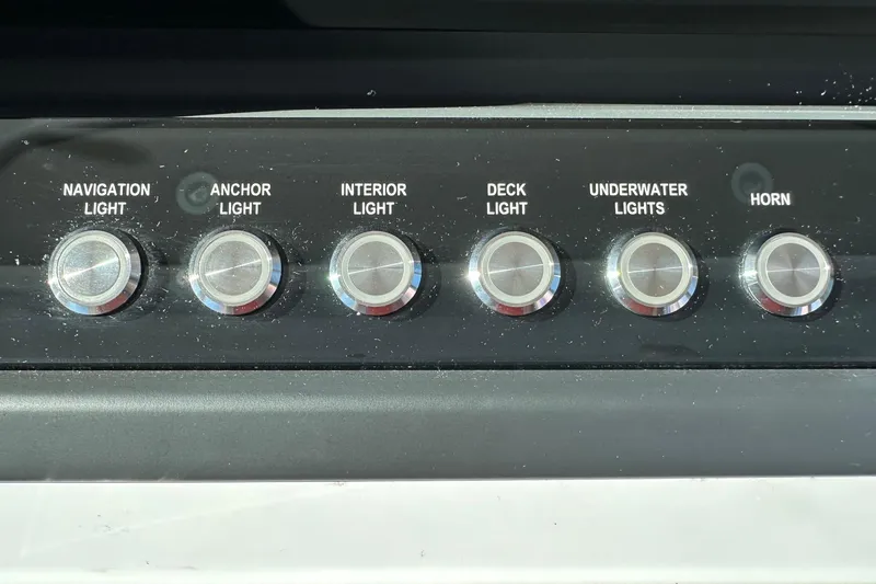 Slide: The Image of Control panel of 2022 Axopar 28 CABIN with light and horn switches. - 26