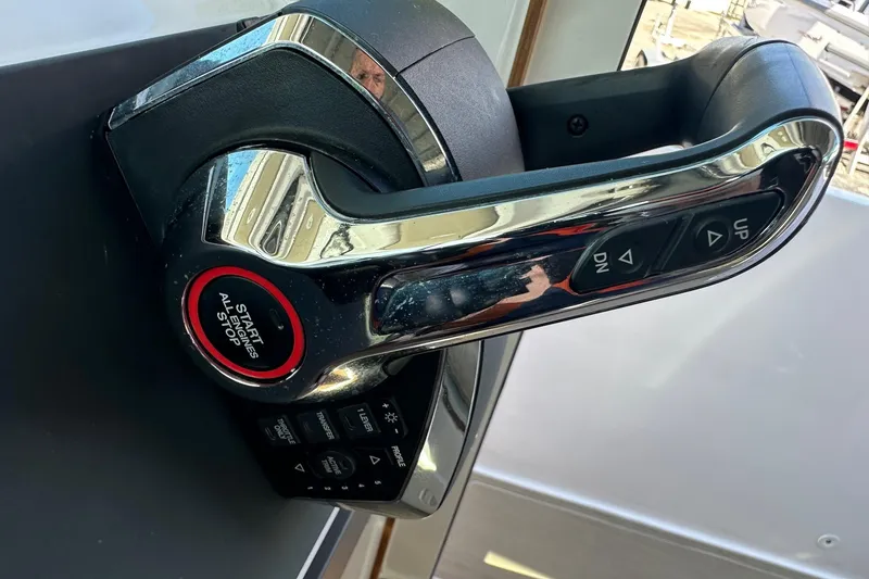 Slide: The Image of Throttle control of 2022 Axopar 28 CABIN boat with start/stop button and trim controls. - 27