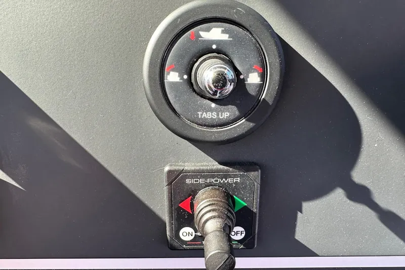 Slide: The Image of Control panel of 2022 Axopar 28 CABIN boat with trim and side-power controls. - 28