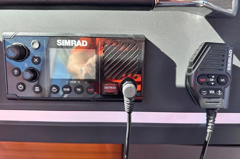 Slide: The Image of Simrad marine radio system on 2022 Axopar 28 CABIN boat dashboard. - 29