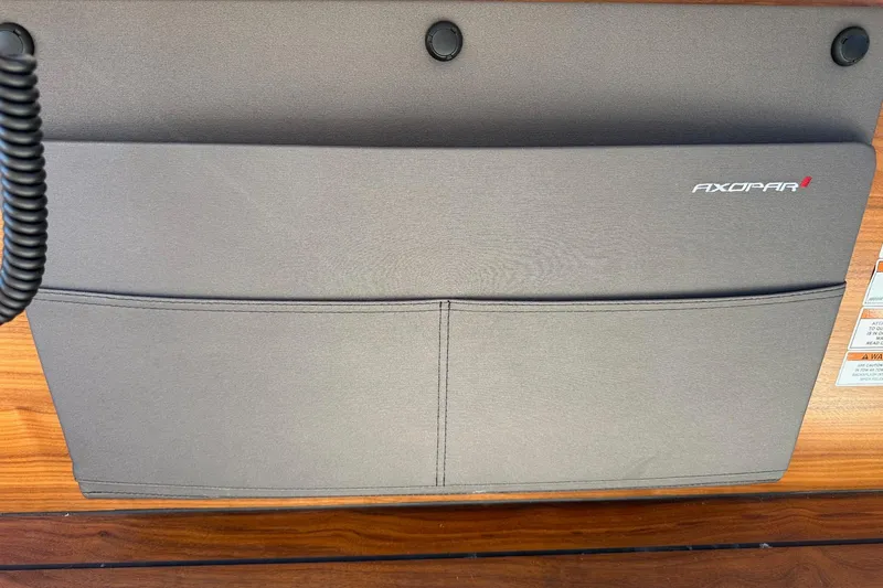 Slide: The Image of 2022 Axopar 28 CABIN interior detail with branded storage pocket. - 31