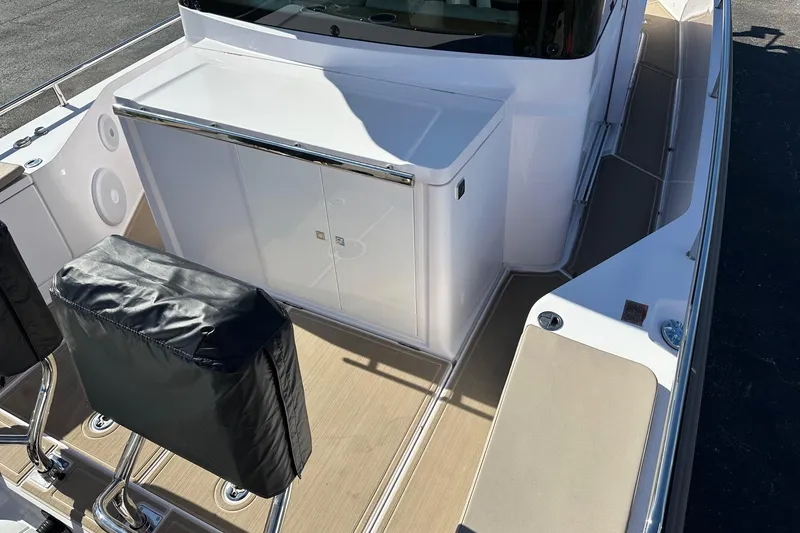 Slide: The Image of 2022 Axopar 28 CABIN boat interior with seating and storage compartments. - 36