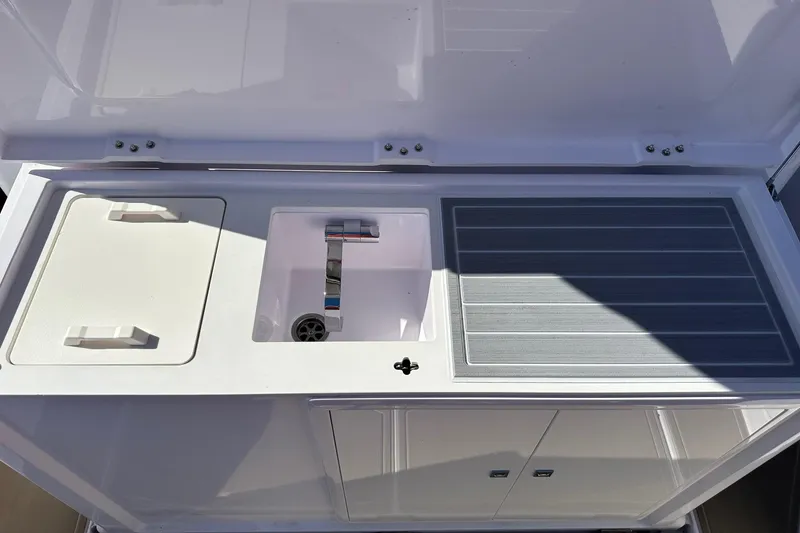 Slide: The Image of 2022 Axopar 28 CABIN boat sink and countertop setup. - 37