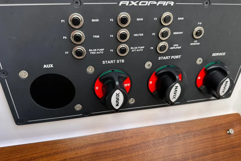 Slide: The Image of Control panel of 2022 Axopar 28 CABIN boat with switches and knobs. - 46