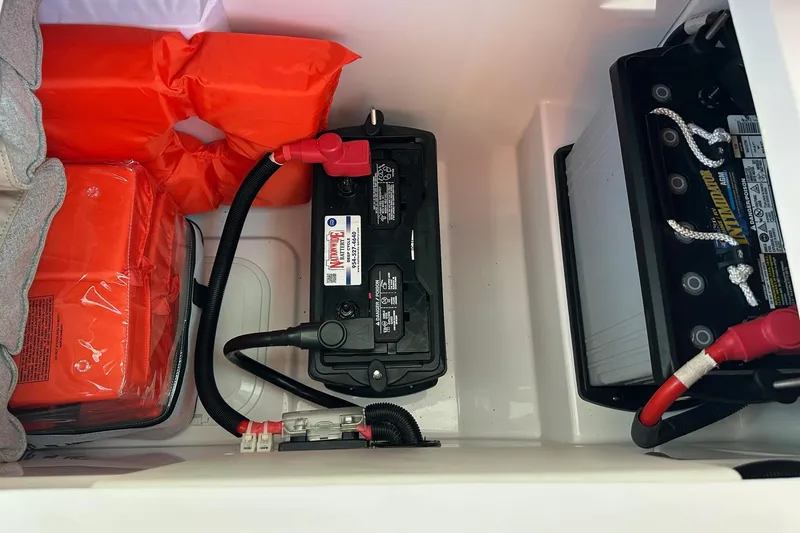 Slide: The Image of Battery compartment of 2022 Axopar 28 CABIN with safety equipment and wiring. - 47
