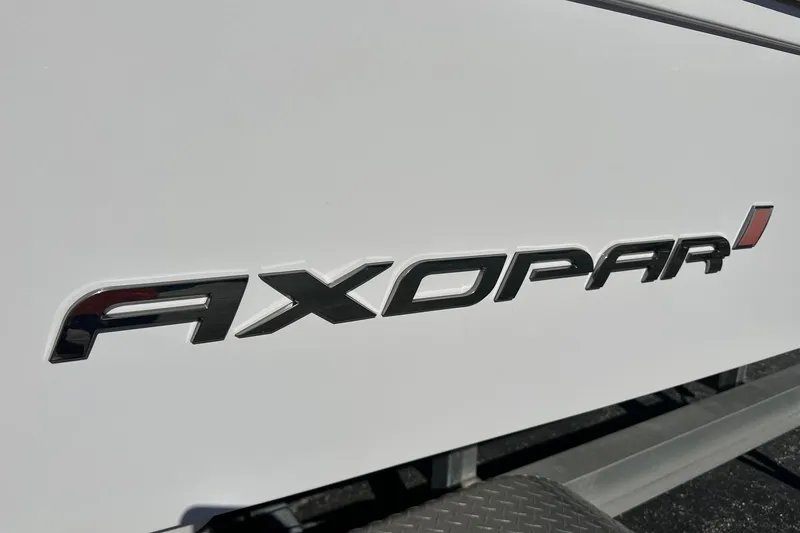 Slide: The Image of Close-up of 2022 Axopar 28 CABIN logo on white surface. - 5