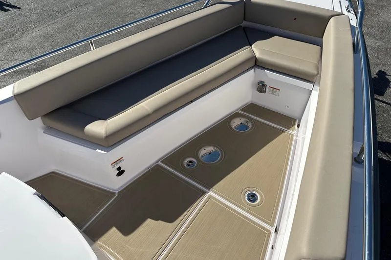 Slide: The Image of 2022 Axopar 28 CABIN boat interior with beige seating and deck hatches. - 8