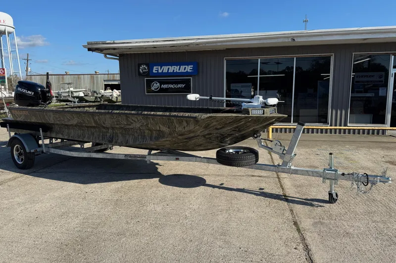 The Image of 2026 SeaArk 1960 Slayer Pro boat on trailer outside dealership. - 1