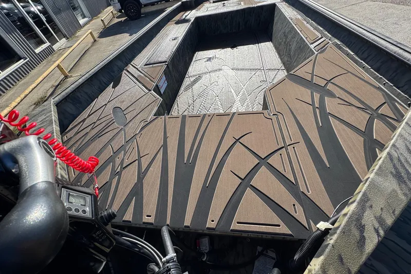 Slide: The Image of 2026 SeaArk 1960 Slayer Pro boat interior with custom flooring design. - 15