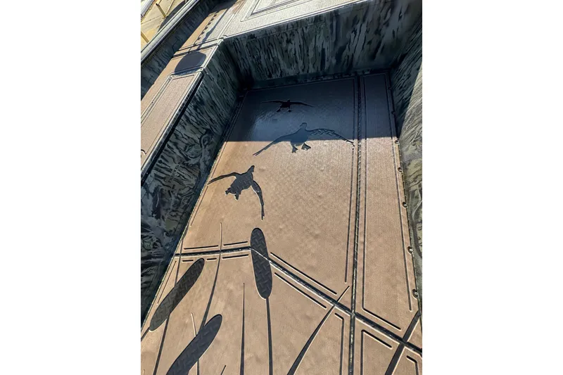 Slide: The Image of 2026 SeaArk 1960 Slayer Pro boat interior with duck and cattail designs. - 17