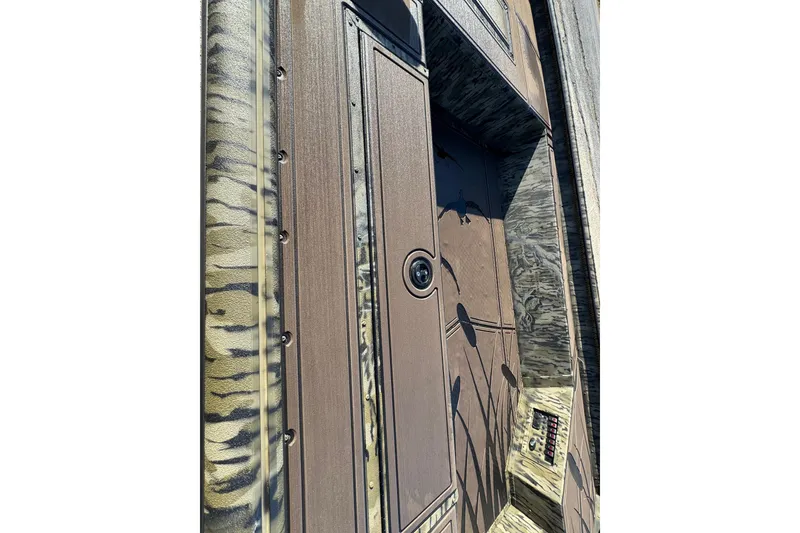 Slide: The Image of Close-up of 2026 SeaArk 1960 Slayer Pro boat with camouflage design. - 18