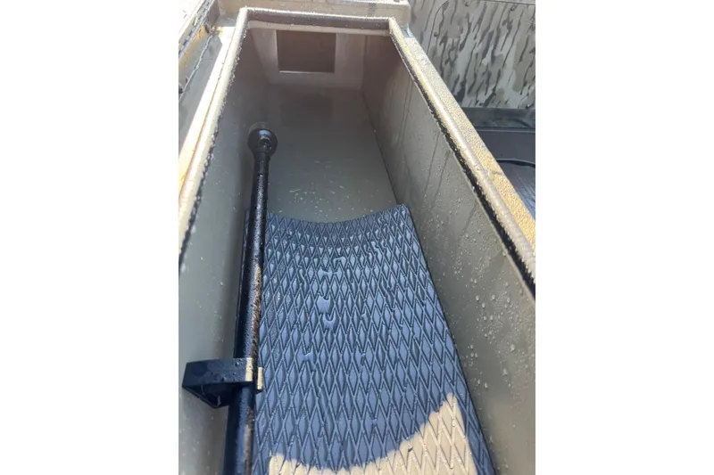 Slide: The Image of Interior view of 2026 SeaArk 1960 Slayer Pro boat compartment with textured flooring. - 20