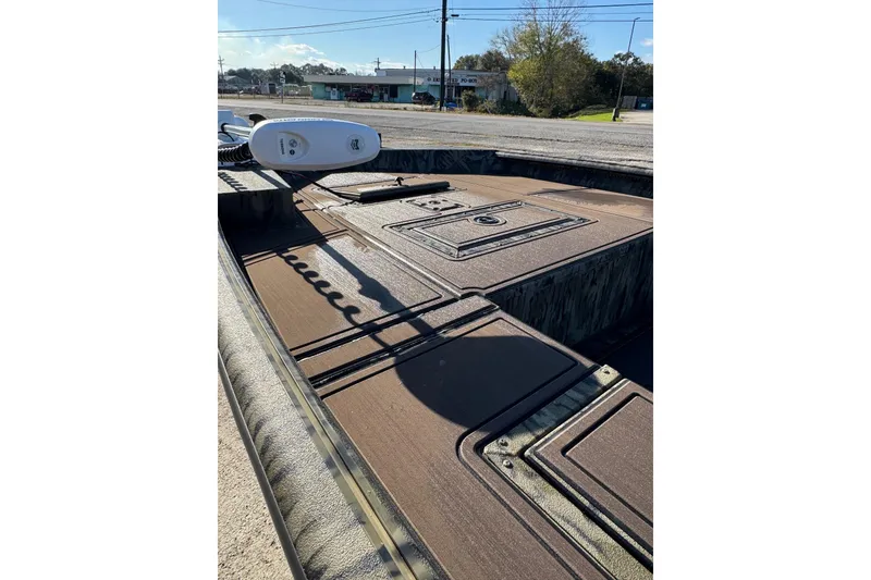 Slide: The Image of 2026 SeaArk 1960 Slayer Pro boat deck with storage compartments and trolling motor. - 22