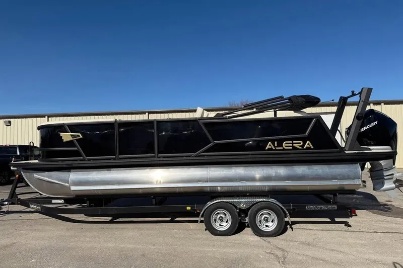 The Image of 2026 Alera MQ23 pontoon boat on trailer, sleek design, black and silver finish. - 0