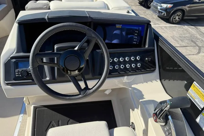 Slide: The Image of 2026 Alera mq23 boat dashboard with steering wheel, control panel, and digital display. - 11