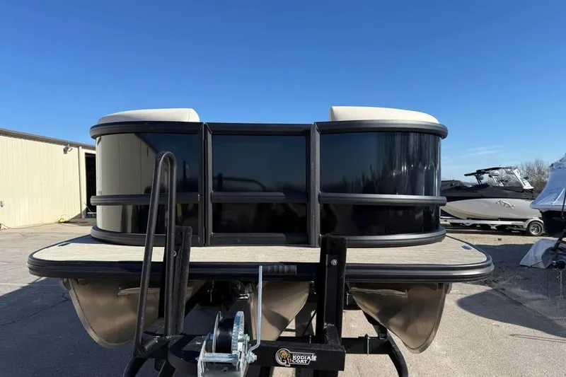 Slide: The Image of 2026 Alera MQ23 pontoon boat on trailer under clear blue sky. - 2