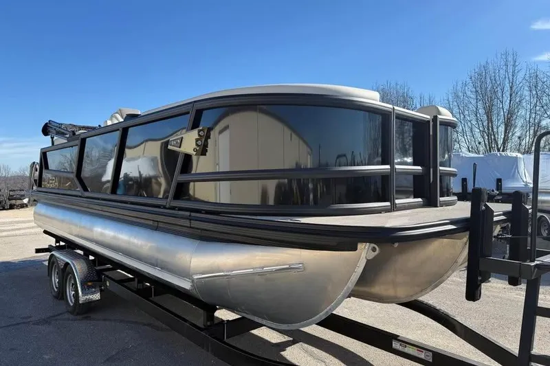 Slide: The Image of Alera MQ23 pontoon boat, 2026 model, on trailer under clear blue sky. - 3