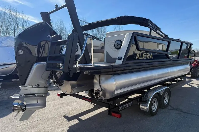 Slide: The Image of 2026 Alera MQ23 pontoon boat on trailer, featuring sleek design and powerful outboard motor. - 5