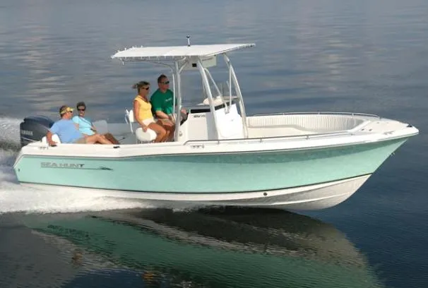 The Image of 2009 Sea Hunt Ultra 232 boat docked on a lift by the water. - 0