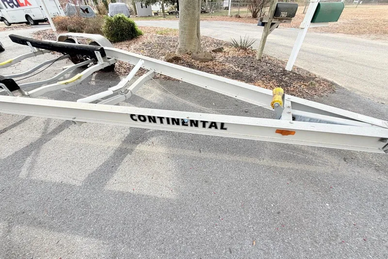 Slide: The Image of Boat trailer for 2009 Sea Hunt Ultra 232, labeled "Continental," parked on pavement. - 15