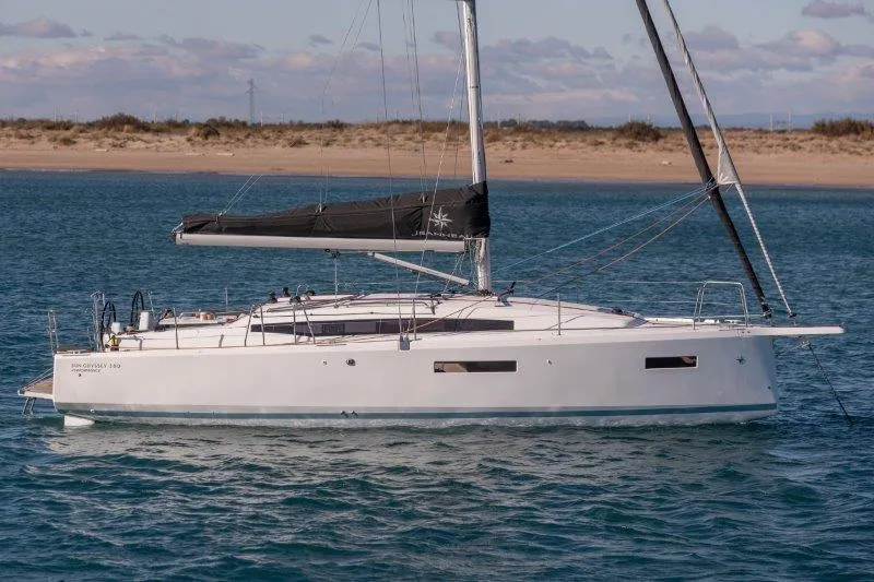 Slide: The Image of 2024 Jeanneau 380 sailboat on calm waters near a sandy shore. - 49
