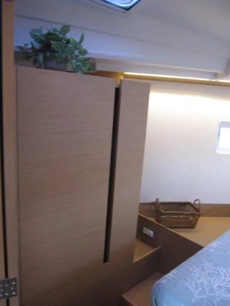 Slide: The Image of Interior of 2024 Jeanneau 380 sailboat with wooden cabinetry and cozy decor. - 22