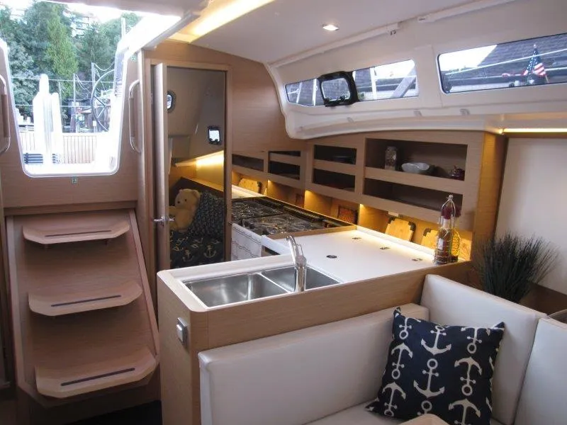 Slide: The Image of Interior of 2024 Jeanneau 380 sailboat with modern kitchen and cozy seating area. - 29