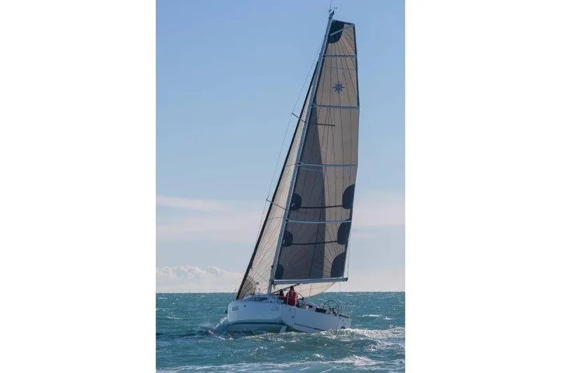 Slide: The Image of 2025 Jeanneau Sun Odyssey 380 sailing on open sea under clear blue sky. - 48