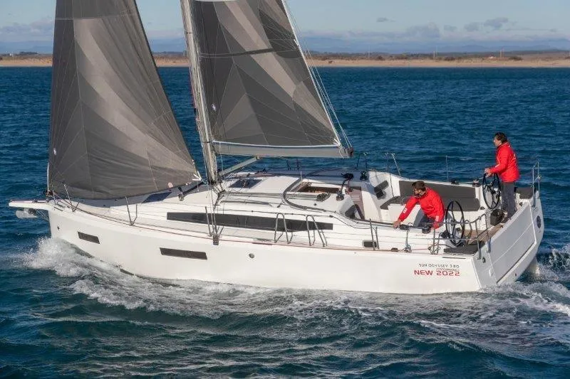 The Image of 2025 Jeanneau Sun Odyssey 380 sailing on open water with two crew members. - 0