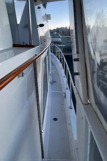 Slide: The Image of 1994 DeFever Double Cabin yacht deck with railing and clear enclosure. - 10