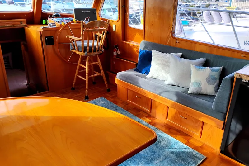 Slide: The Image of 1994 DeFever Double Cabin interior with wooden helm, seating, and nautical decor. - 13