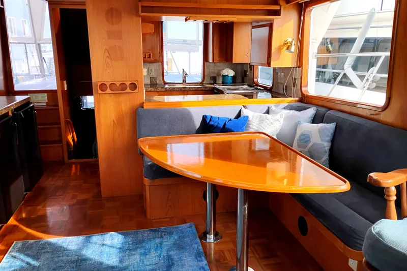 Slide: The Image of Cozy interior of 1994 DeFever Double Cabin yacht with wooden dining area and plush seating. - 14