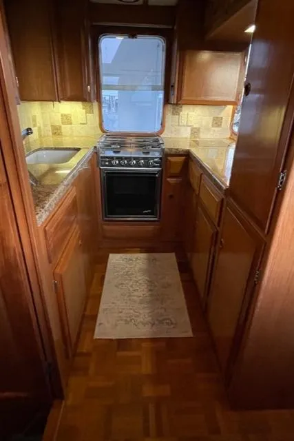 Slide: The Image of 1994 DeFever Double Cabin kitchen with wood cabinetry, stove, and sink. - 15