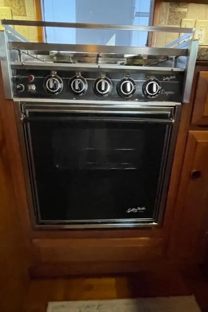 Slide: The Image of 1994 DeFever Double Cabin stove with multiple burners and oven in a wooden kitchen setting. - 16